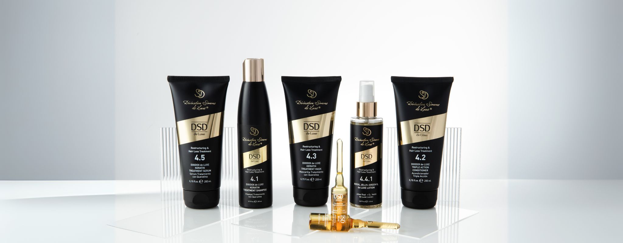 A selection of DSD de Luxe Hair Care Kits, featuring comprehensive product regimens for hair loss treatment, scalp care, and hair fiber repair.